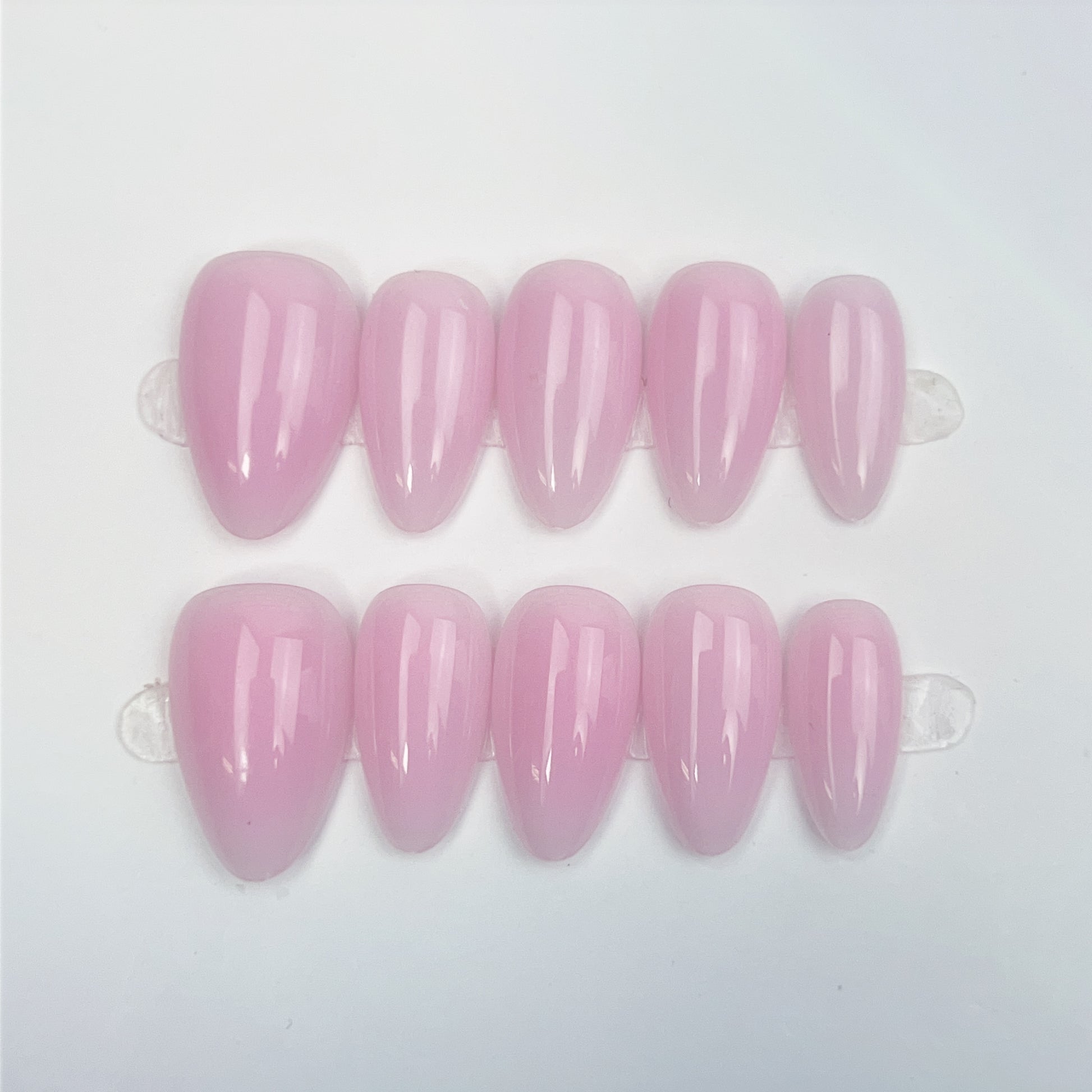 Close-up of Rosy Blush short press-on nails in a soft translucent pink shade