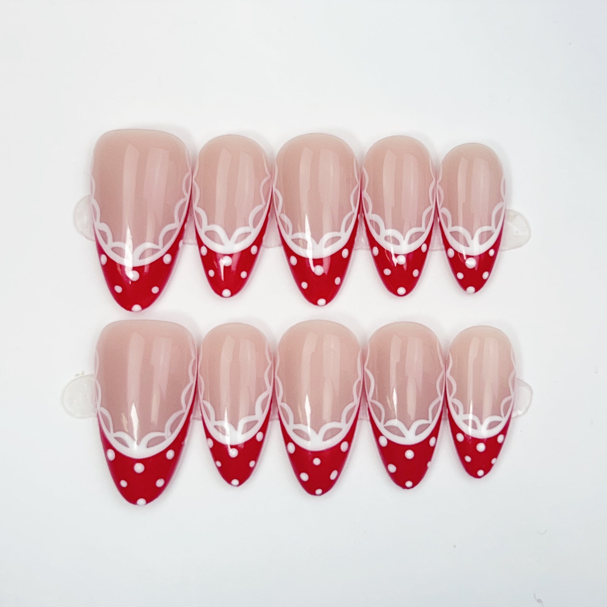 Cherry Lace medium almond press-on nails on a soft nude base