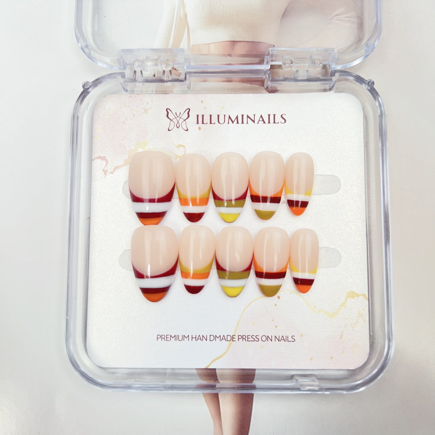 Sunset Stripe handmade French press-on nails with colorful striped tips in coral, orange, yellow and berry tones