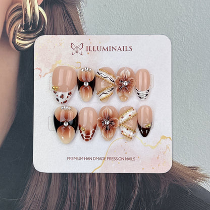 Mocha Muse short almond nails with black ombré tips and animal-print accents