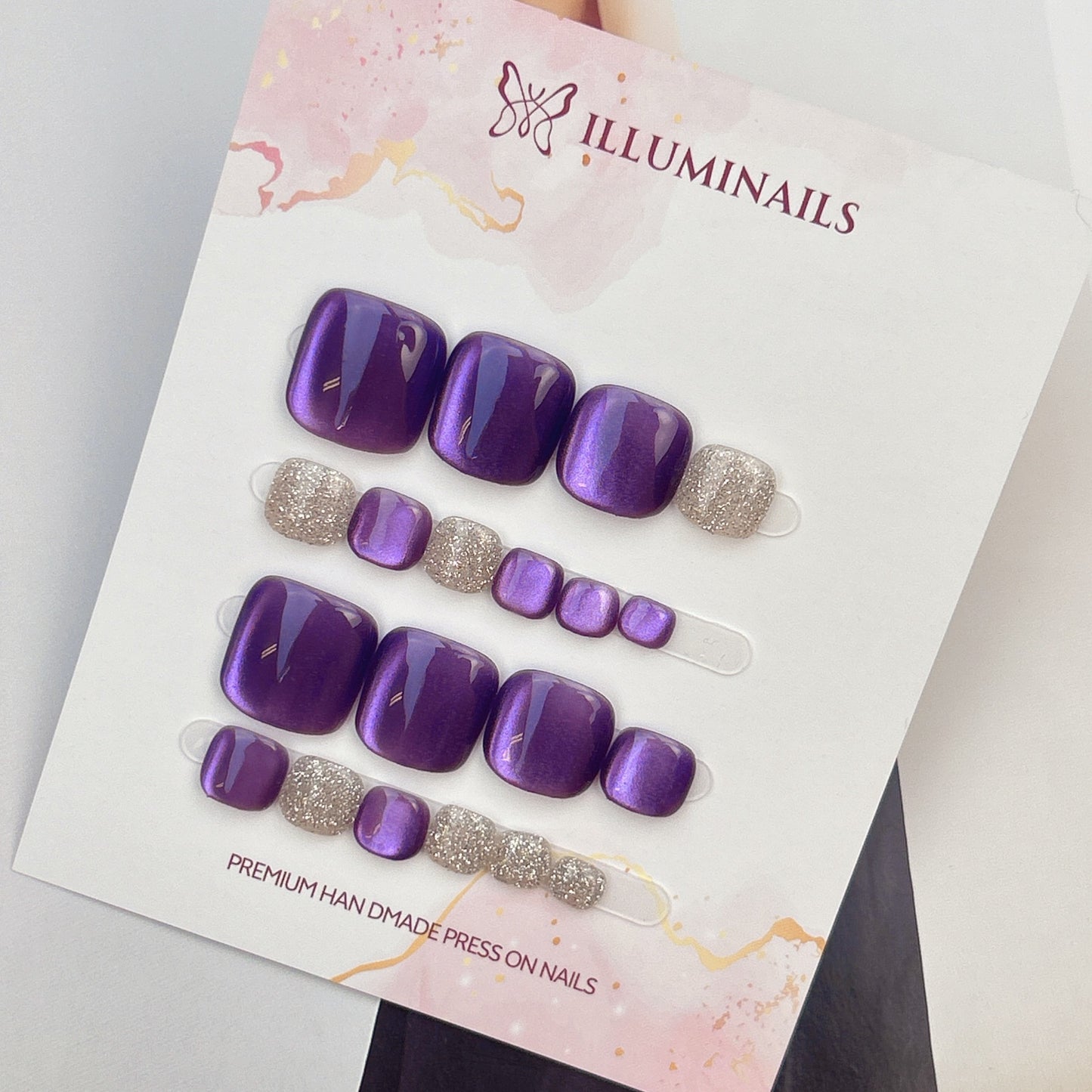 Star Sand press-on toenails in Amethyst Purple cat eye with silver glitter accent toes