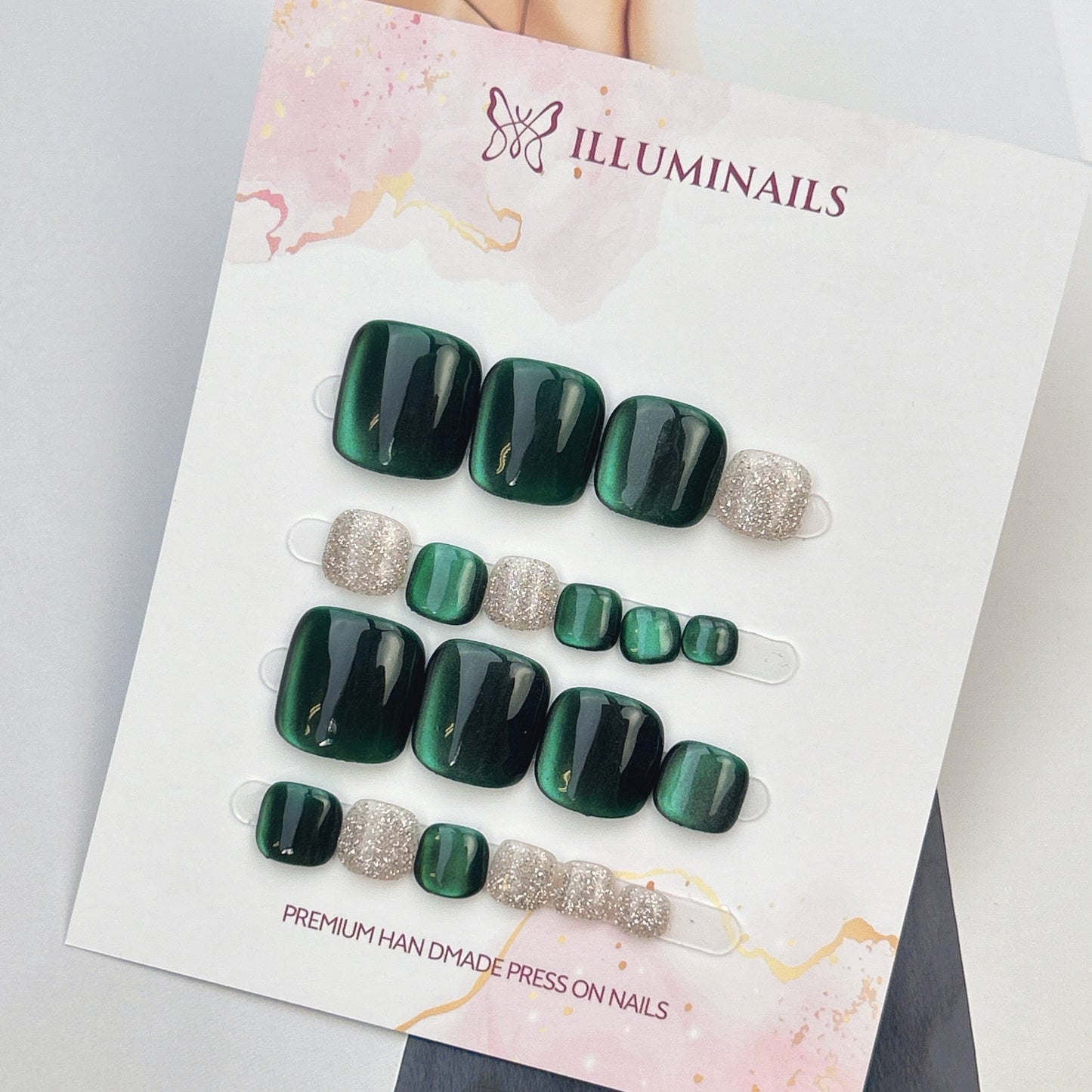 Star Sand press-on toenails in Emerald Green cat eye with silver glitter accent toes