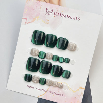 Star Sand press-on toenails in Emerald Green cat eye with silver glitter accent toes