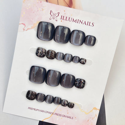 Star Sand press-on toenails in Midnight Silver cat eye with dark glitter accent toes