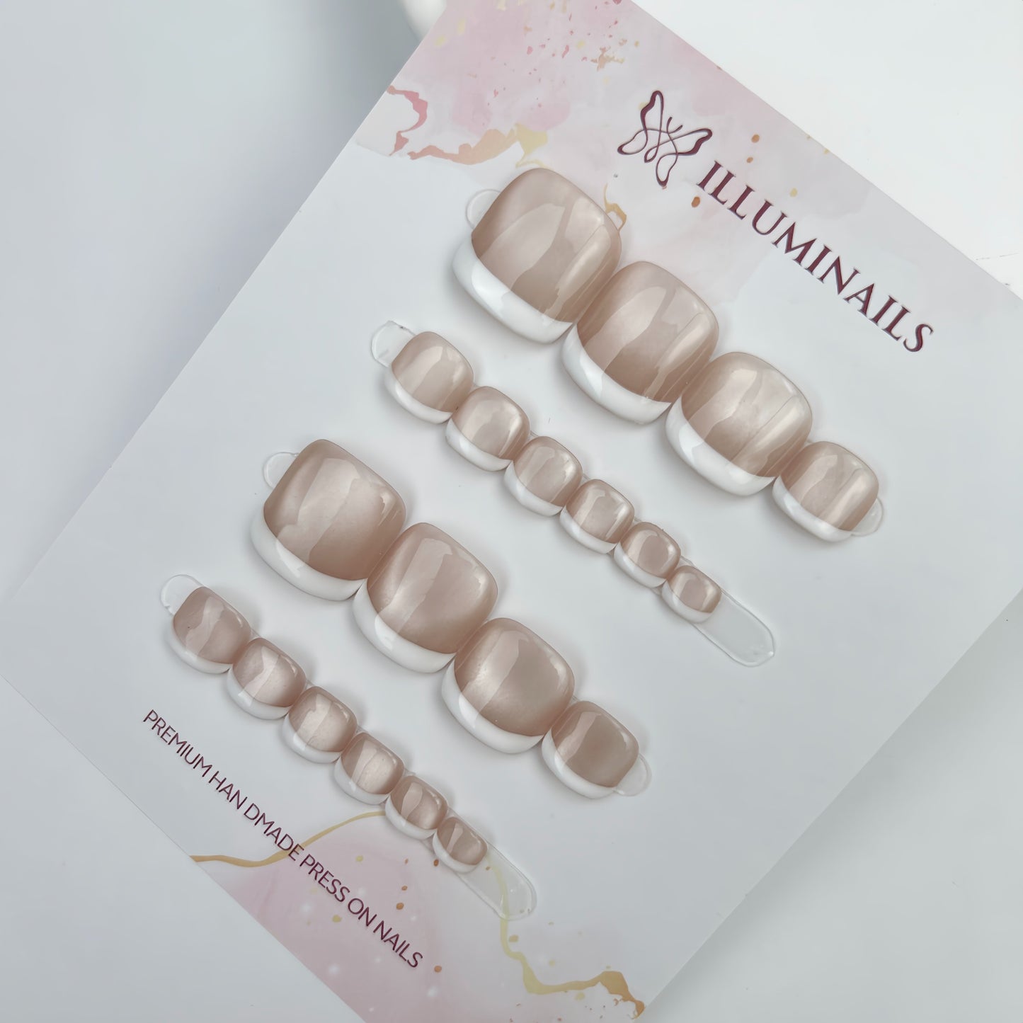 White French cat eye press-on toenails displayed on Illuminails card