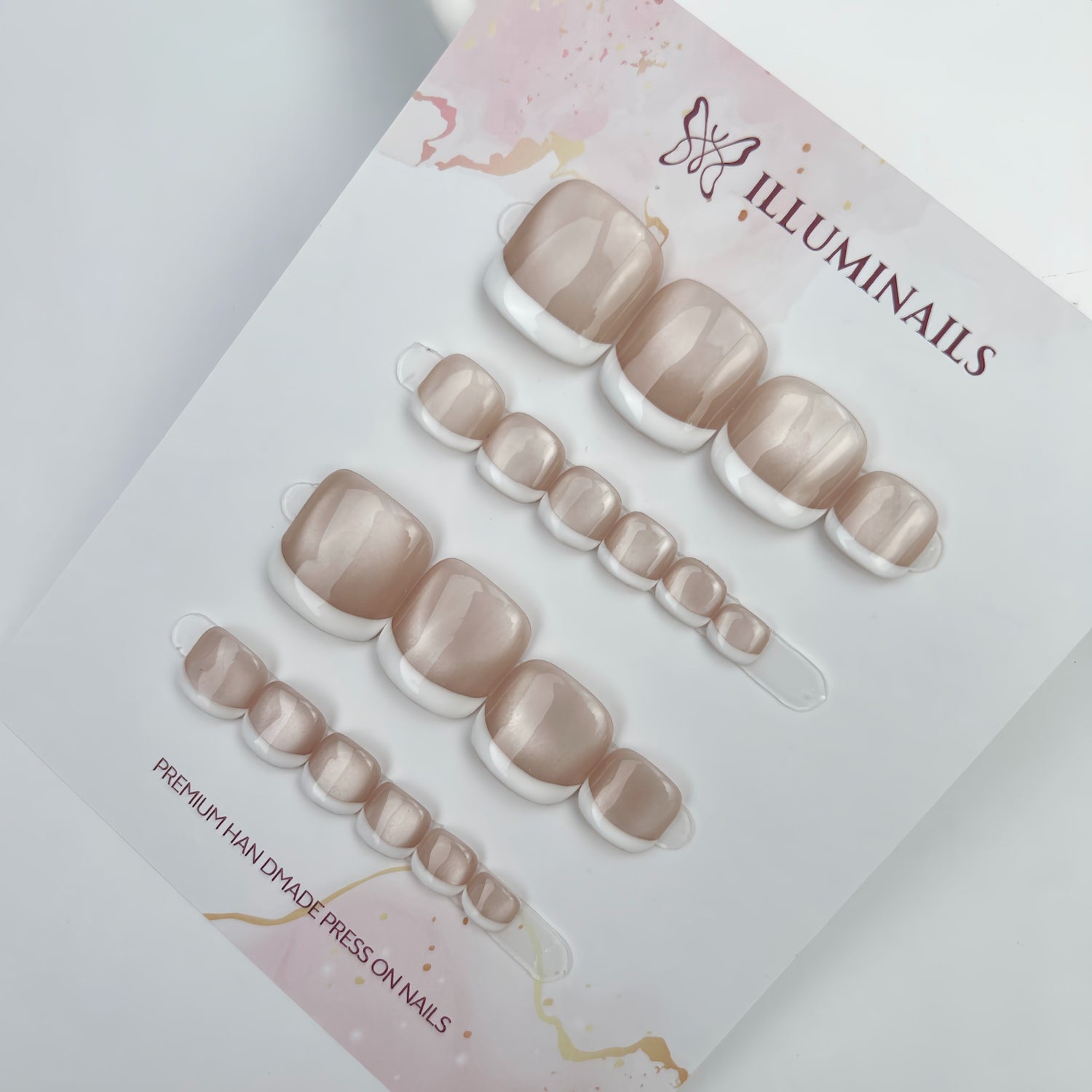 White French cat eye press-on toenails displayed on Illuminails card