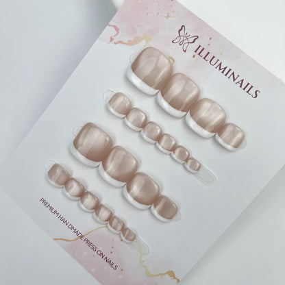 White French cat eye press-on toenails displayed on Illuminails card